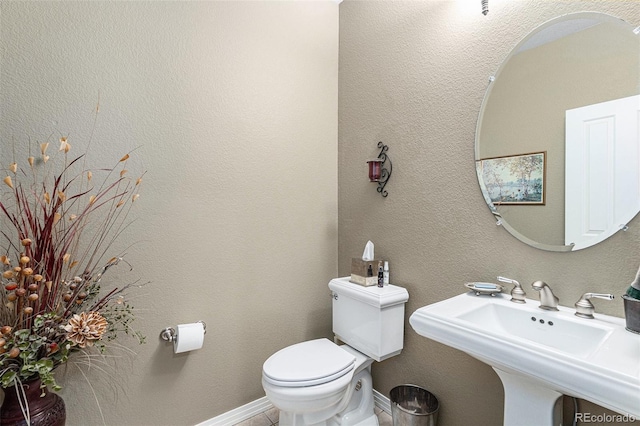 11422 W Cooper Ave, Littleton, CO 80127 - bathroom featuring a sink, toilet, and baseboards