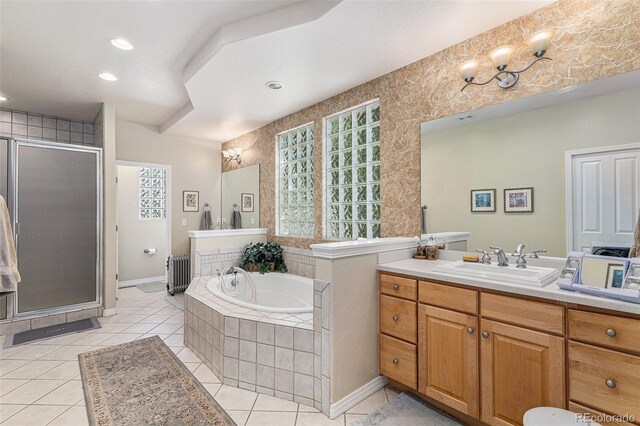 11422 W Cooper Ave, Littleton, CO 80127 - bathroom with radiator heating unit, a stall shower, tile patterned flooring, a bath, and vanity