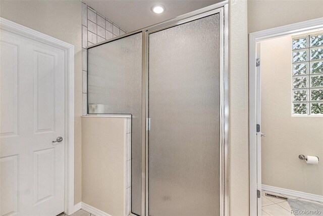11422 W Cooper Ave, Littleton, CO 80127 - full bath featuring a shower stall, baseboards, and tile patterned floors