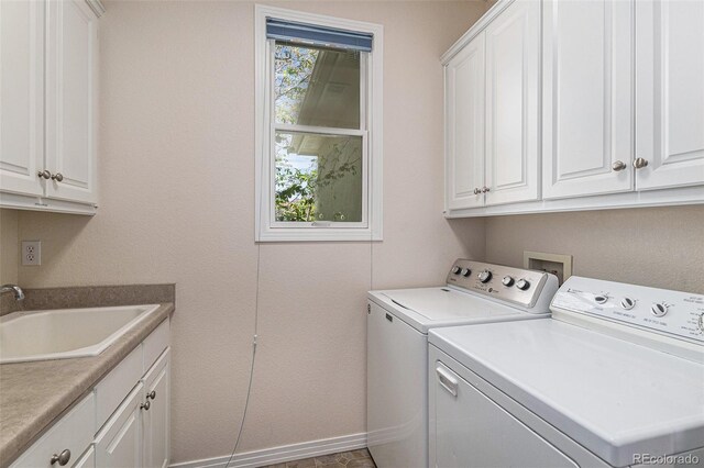 11422 W Cooper Ave, Littleton, CO 80127 - laundry room featuring washing machine and clothes dryer, cabinet space, and baseboards