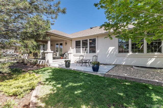 11422 W Cooper Ave, Littleton, CO 80127 - rear view of property featuring stucco siding, a yard, and a patio area