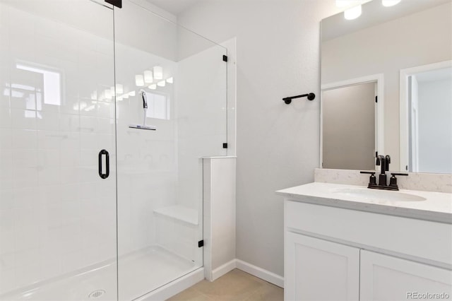 bathroom with tile patterned flooring, vanity, and an enclosed shower