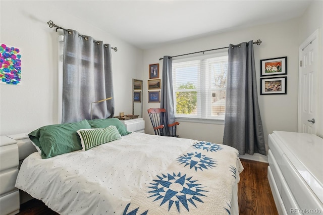 bedroom with dark wood-style floors