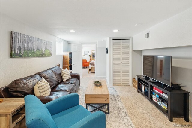 carpeted living room featuring visible vents and recessed lighting