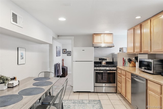 kitchen featuring light tile patterned floors, under cabinet range hood, visible vents, appliances with stainless steel finishes, and light brown cabinetry