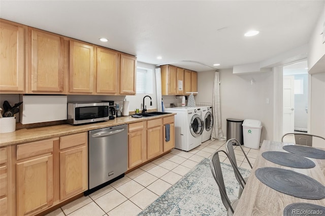 kitchen featuring independent washer and dryer, a sink, light brown cabinetry, and stainless steel appliances