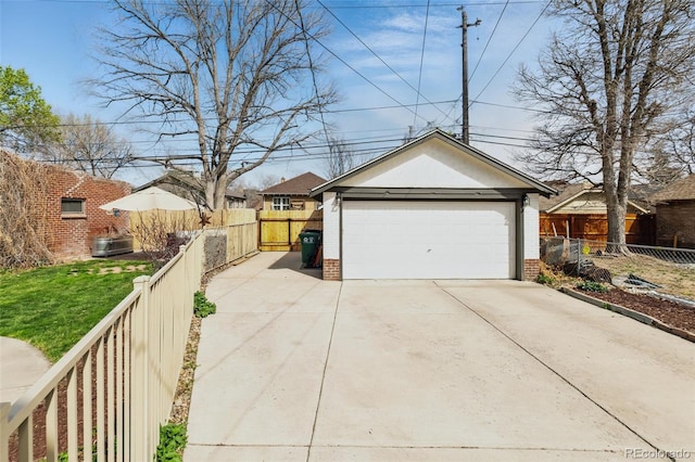 detached garage featuring fence