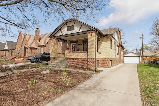 view of front of property with a porch, a detached garage, an outdoor structure, and brick siding