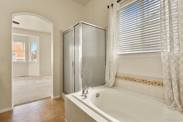 297 N Coolidge Way, Aurora, CO 80018 - full bathroom with a bath, a stall shower, baseboards, and tile patterned flooring