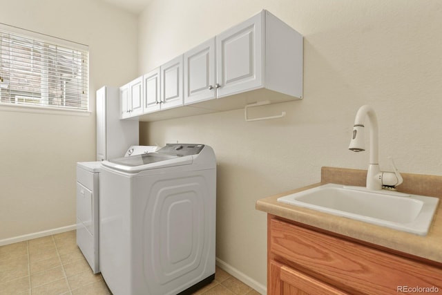 297 N Coolidge Way, Aurora, CO 80018 - washroom featuring washing machine and clothes dryer, cabinet space, light tile patterned floors, and baseboards