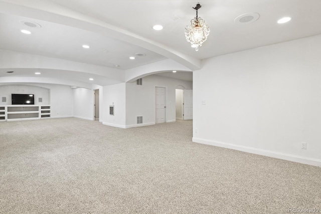 297 N Coolidge Way, Aurora, CO 80018 - unfurnished living room with recessed lighting, arched walkways, light colored carpet, and baseboards