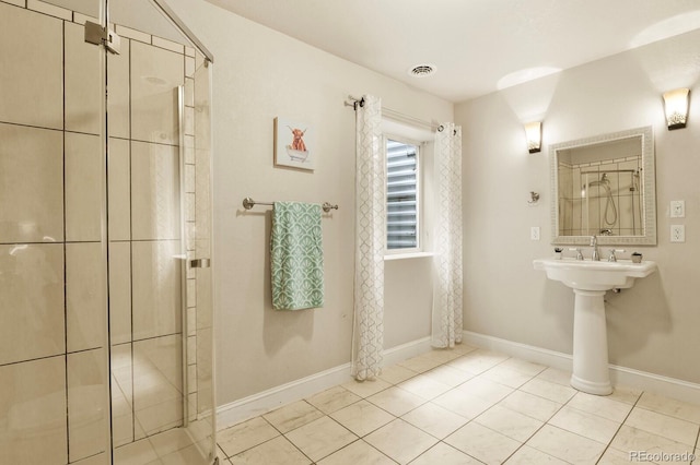 297 N Coolidge Way, Aurora, CO 80018 - full bathroom with a stall shower, baseboards, and tile patterned floors