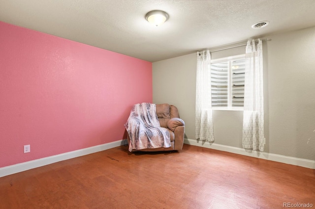 297 N Coolidge Way, Aurora, CO 80018 - living area featuring wood finished floors, baseboards, and a textured ceiling