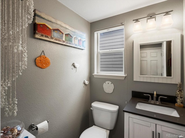 bathroom featuring toilet and vanity