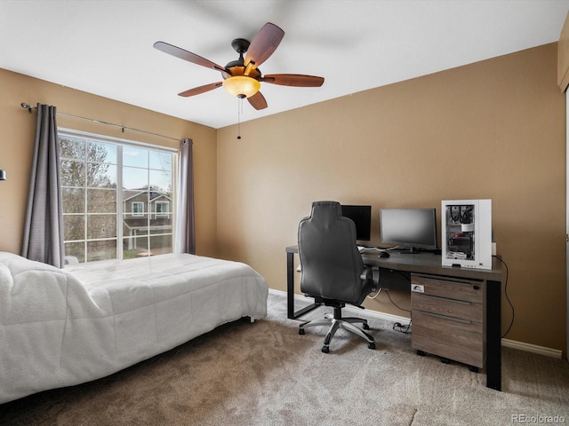 carpeted bedroom with baseboards, a desk, and a ceiling fan