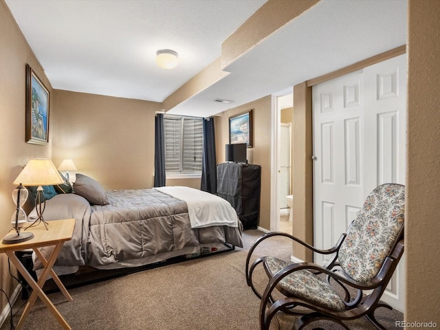bedroom with carpet and connected bathroom