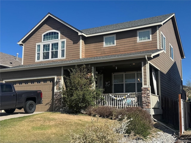 craftsman inspired home featuring covered porch, roof with shingles, an attached garage, and stone siding