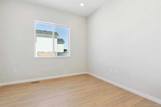 spare room featuring light hardwood / wood-style flooring