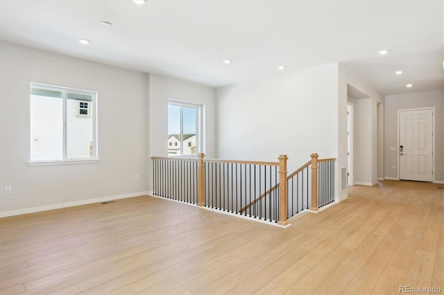 spare room with light hardwood / wood-style flooring