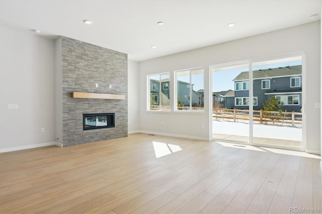 unfurnished living room featuring a fireplace and light wood-type flooring