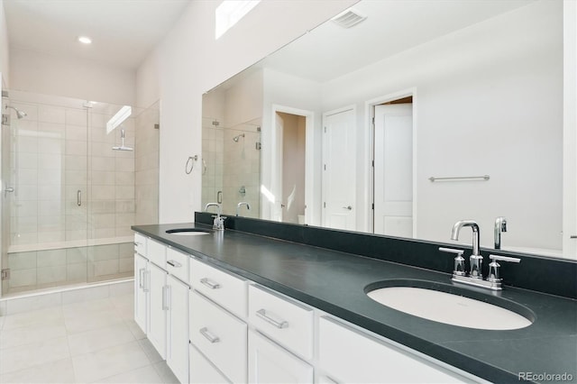 bathroom featuring tile patterned flooring, vanity, and walk in shower