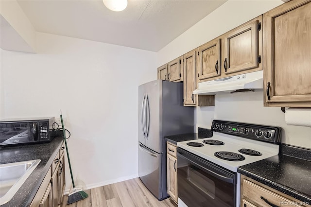 kitchen featuring white electric range, sink, light wood-type flooring, and stainless steel refrigerator