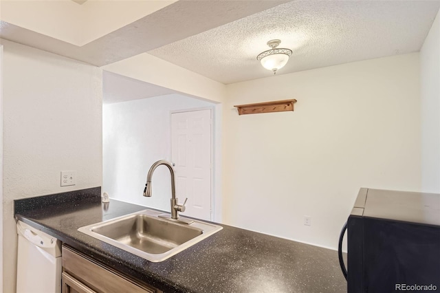 kitchen with a textured ceiling, sink, and dishwasher