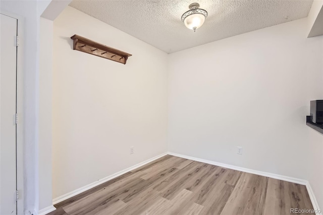 unfurnished room featuring hardwood / wood-style floors and a textured ceiling