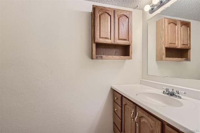 bathroom with vanity and a textured ceiling