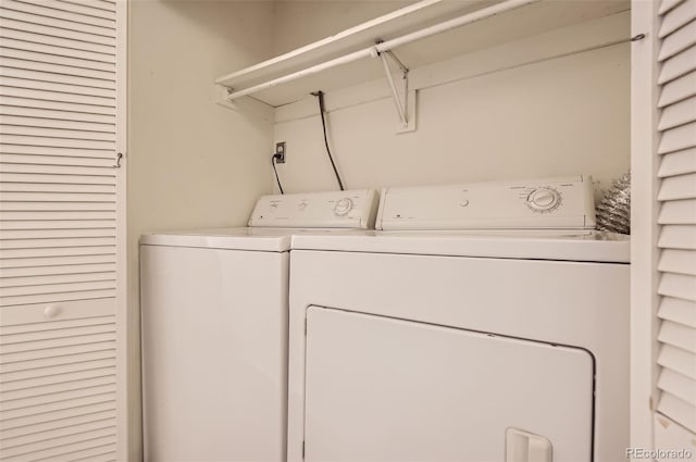 washroom with washing machine and clothes dryer