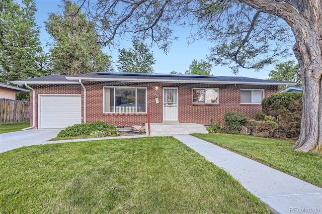 2982 S Vrain St, Denver, CO 80236 - single story home featuring brick siding, a garage, solar panels, and concrete driveway