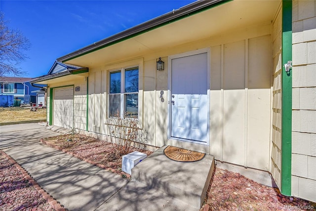 entrance to property with a garage and board and batten siding