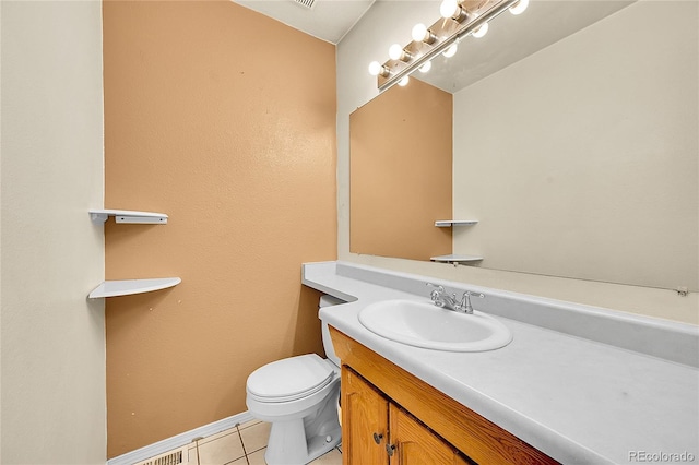 half bath featuring visible vents, toilet, tile patterned flooring, baseboards, and vanity