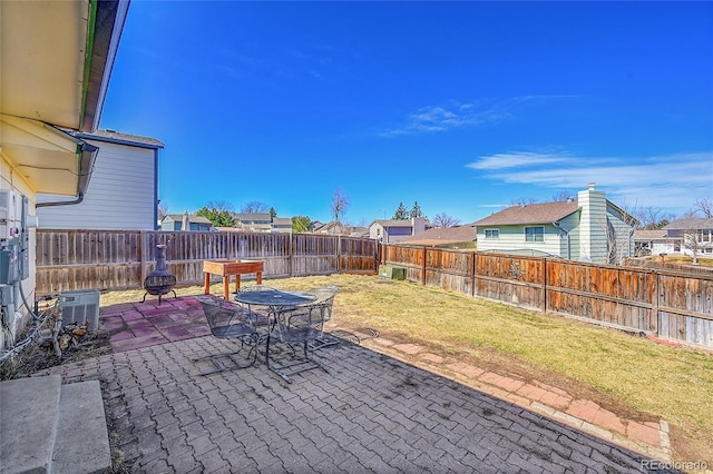 view of patio / terrace with a residential view, central air condition unit, and a fenced backyard