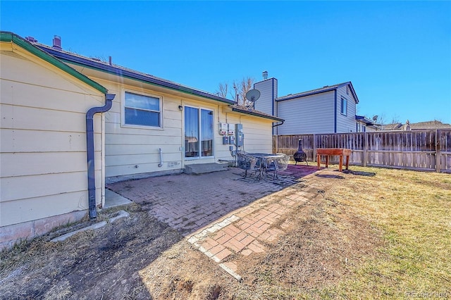 rear view of property with a lawn, a patio, and fence