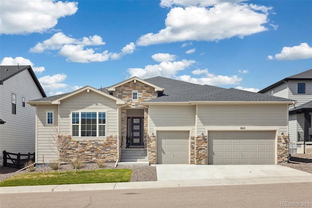view of front of house featuring concrete driveway, stone siding, and a garage