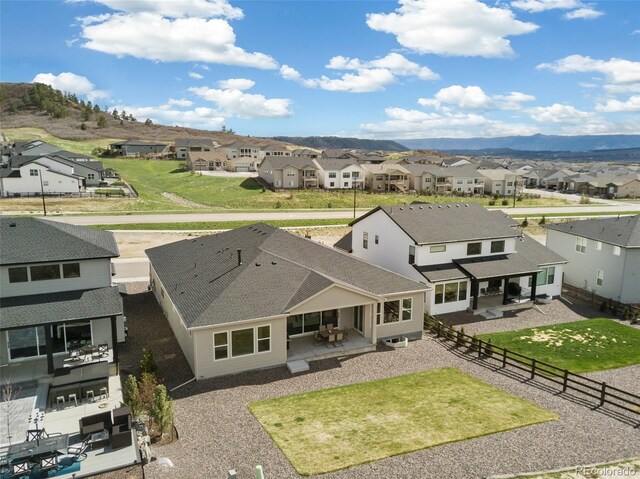 drone / aerial view with a residential view and a mountain view
