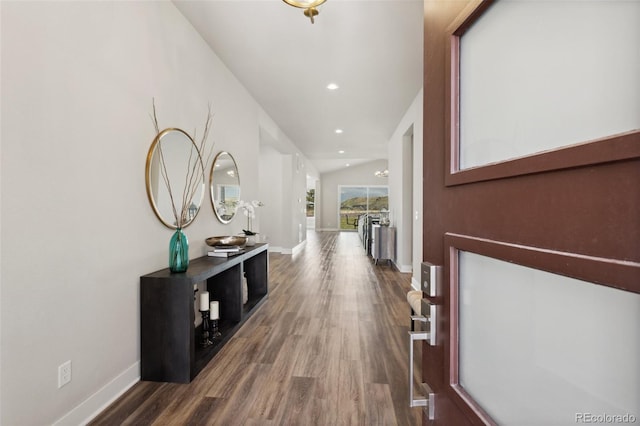 hall featuring baseboards, recessed lighting, and wood finished floors