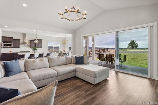 living room featuring recessed lighting, a notable chandelier, dark wood-style floors, and vaulted ceiling