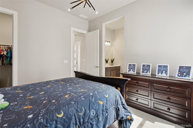 carpeted bedroom with visible vents and a closet