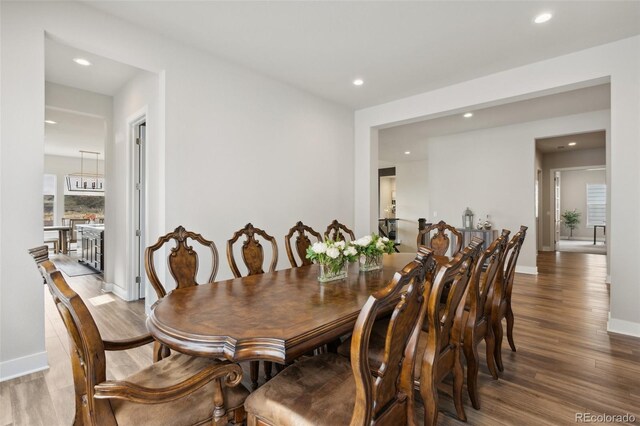 dining room featuring recessed lighting, baseboards, and wood finished floors