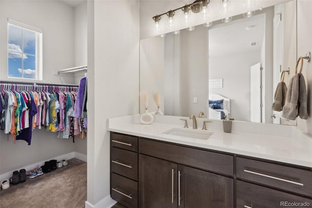 bathroom with baseboards and vanity