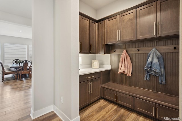 mudroom with baseboards and light wood-style flooring