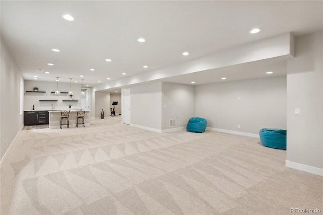 exercise room with visible vents, light carpet, baseboards, recessed lighting, and wet bar