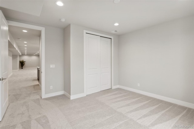 unfurnished bedroom with recessed lighting, baseboards, and light colored carpet