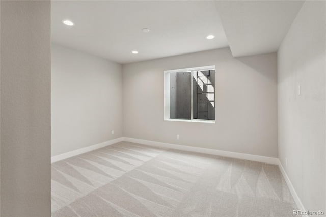 spare room with recessed lighting, carpet flooring, and baseboards
