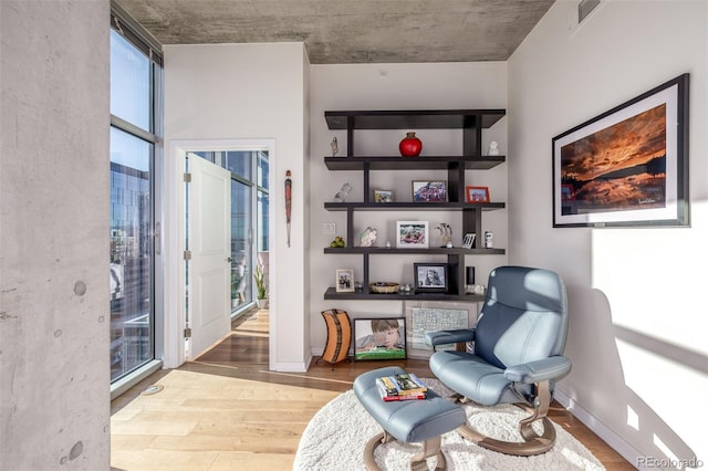 sitting room featuring light hardwood / wood-style flooring and floor to ceiling windows