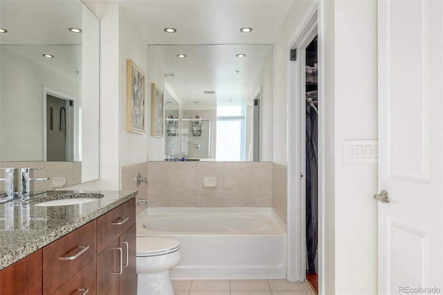 full bathroom with tile patterned flooring, vanity, shower with separate bathtub, and toilet