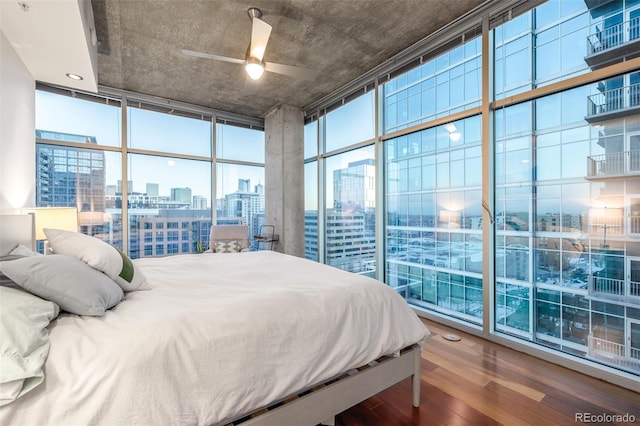 bedroom with multiple windows, hardwood / wood-style flooring, and floor to ceiling windows