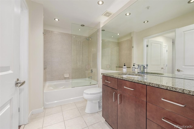 full bathroom with vanity, bath / shower combo with glass door, tile patterned floors, and toilet